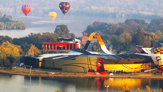 Hot air balloons over National Museum of Australia